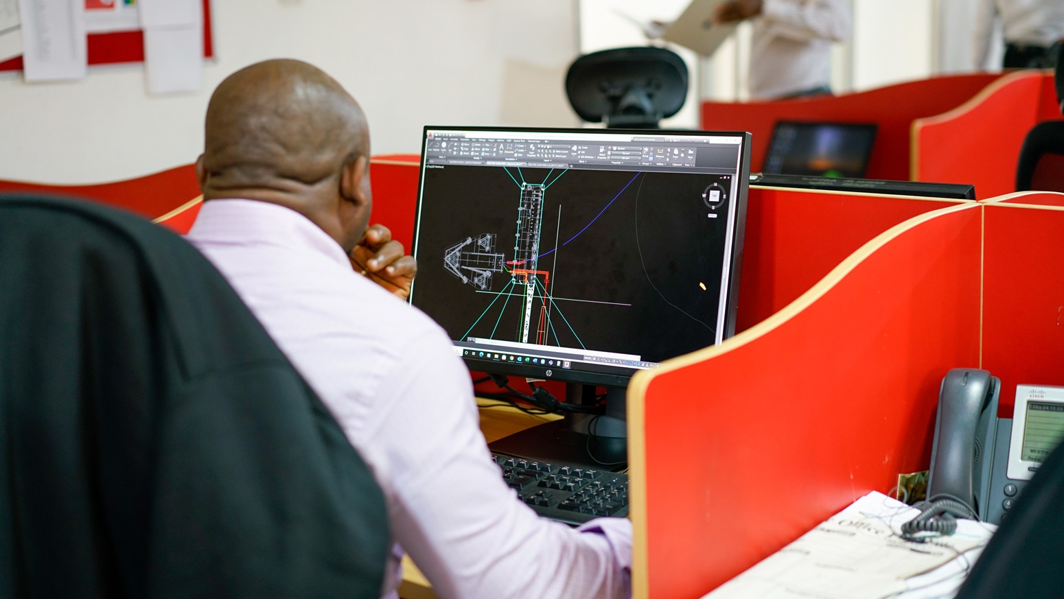 Nigerian engineer working on a technical design